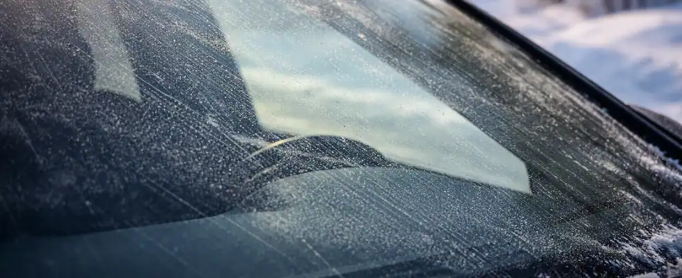 Close-up of a windshield surface showing fine streaks