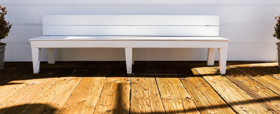 Wet wood bench after a soft wash pressure washing