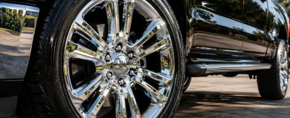 Shiny chrome wheel under bright sunlight