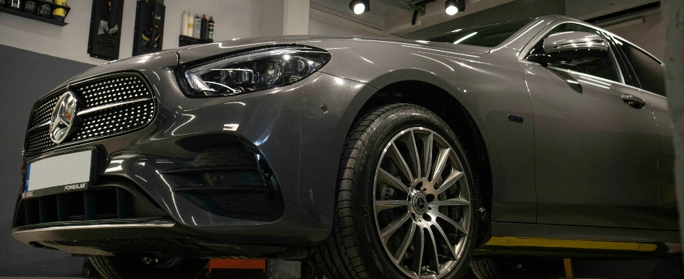 a car is parked in a garage with lights on