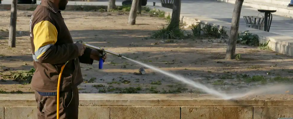 man in brown jacket holding black and gray stick