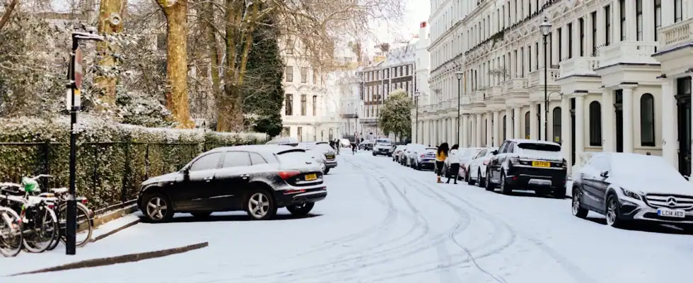 a pile of cars covered in snow