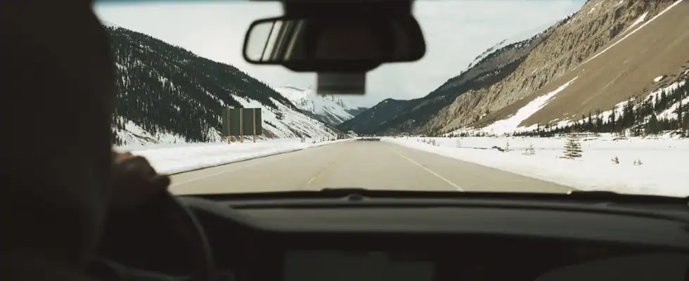 view from inside a car showing snow-covered roads